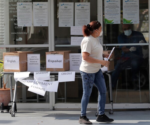 a woman picks up an unemployment form in florida