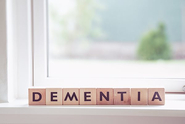 wooden tiles on a windowsill that spell out dementia