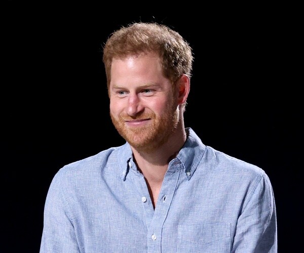 prince harry stands onstage