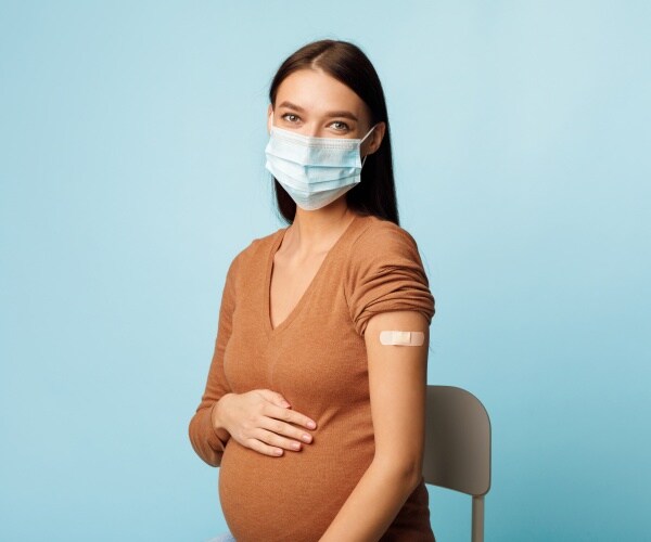 pregnant woman with band-aid on arm