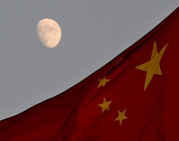 a chinese flag against a moon