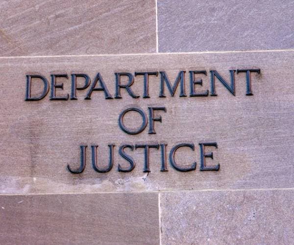 the department of justice written on the side of the agencies building