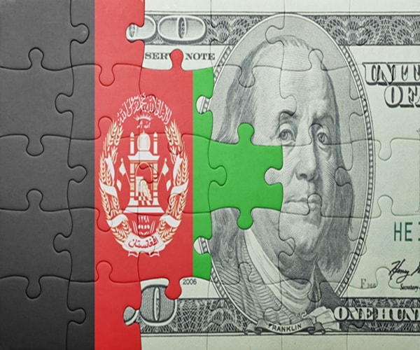 puzzle with the national flag of afghanistan and usa dollar banknote .