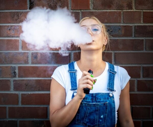 young adult woman vaping