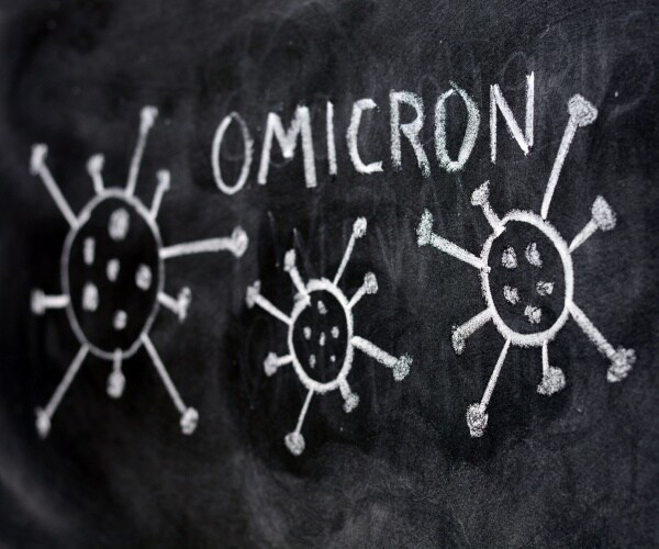 Written in white on chalkboard "omicron" and images of three coronaviruses