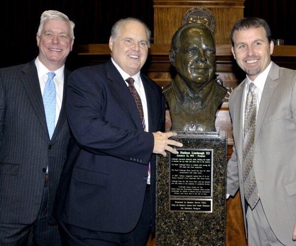 limbaugh stands with kinder and tilley with a bust of limbaugh