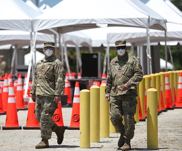 national guard are at a coronavirus testing site out in a parling lot