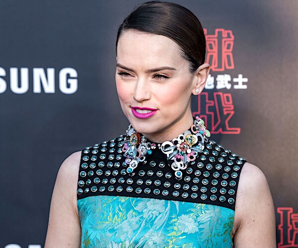 daisy ridley stops for a photo during a red carpet appearance