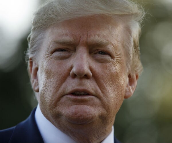 president donald trump pauses as he talks to media before boarding maine one at the white house