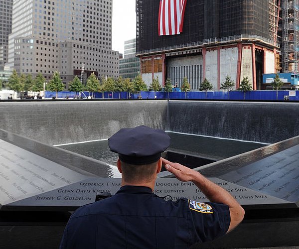 police officer salutes at 9/11 memorial