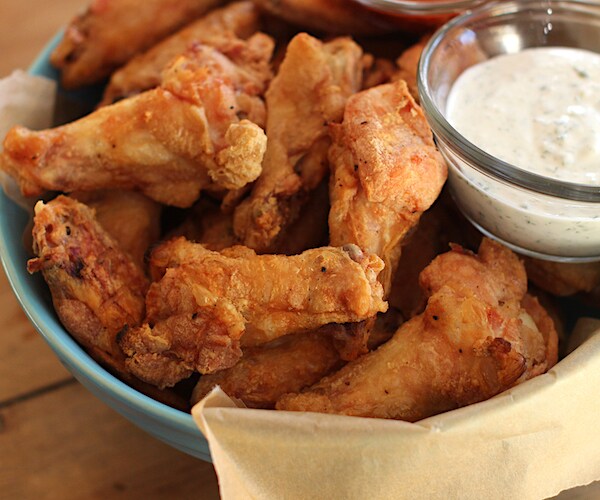 a basket of mouth-watering chicken wings with a succulent side of bleu cheese