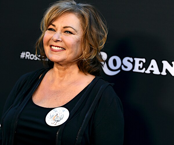 roseanne barr smiles wide on a red carpet