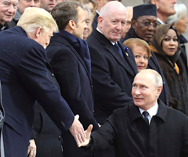 president donald trump shakes hands with russia's vladimir putin