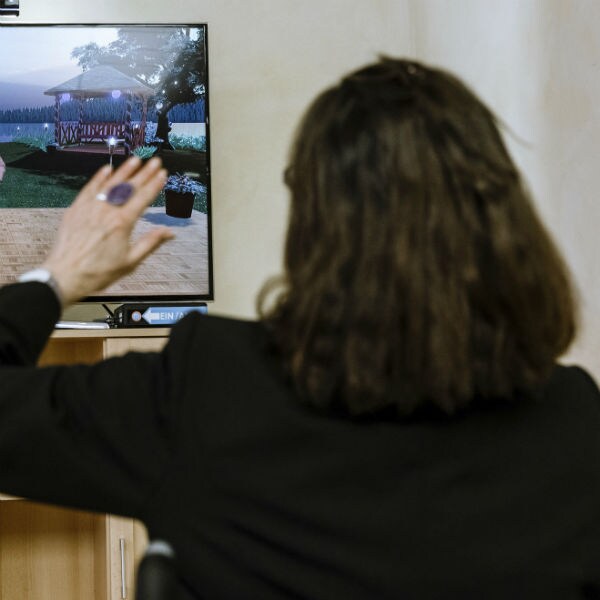 a woman does physical therapy while looking at a video screen