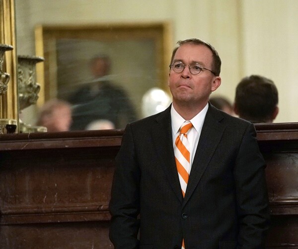 mick mulvaney in the east room listening to the president