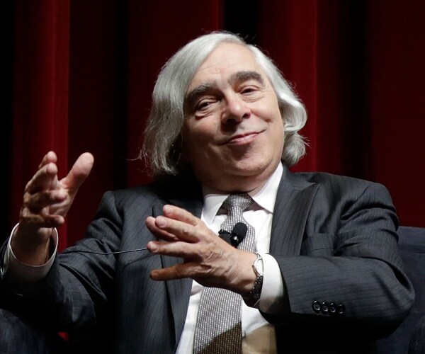 ernest moniz sits onstage