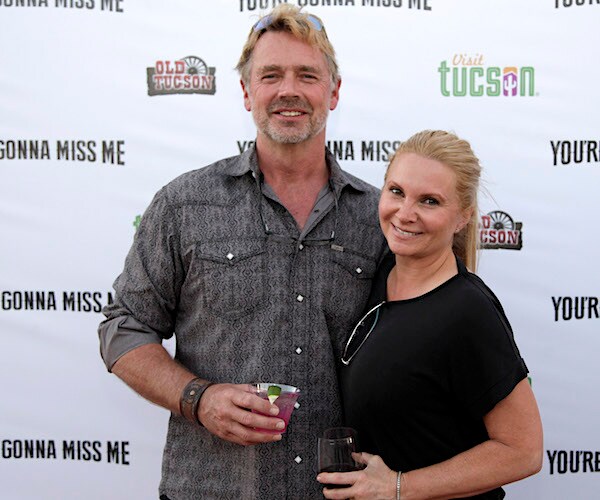 John and Alicia Allain Schneider smile on the red carpet