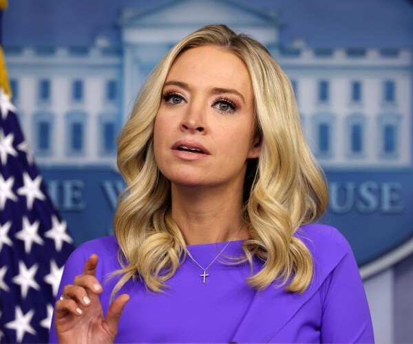 kayleigh mcenany stands at podium in front of white house seal