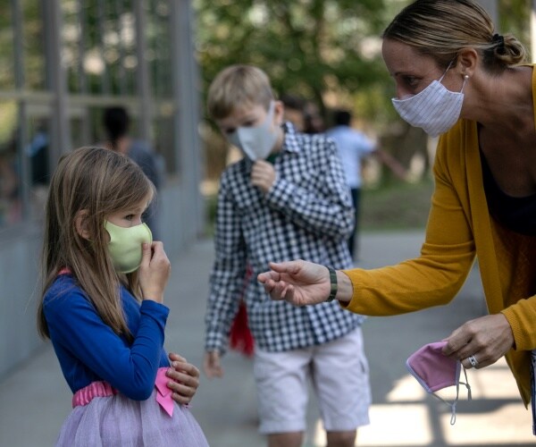 children and teacher wearing masks