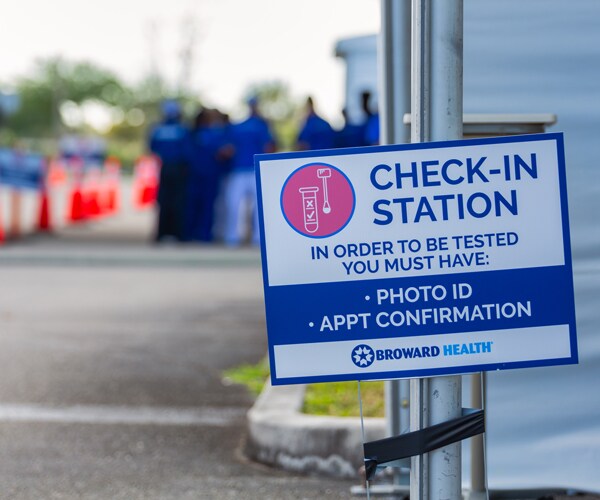 a sign for a coronavirus test site in florida