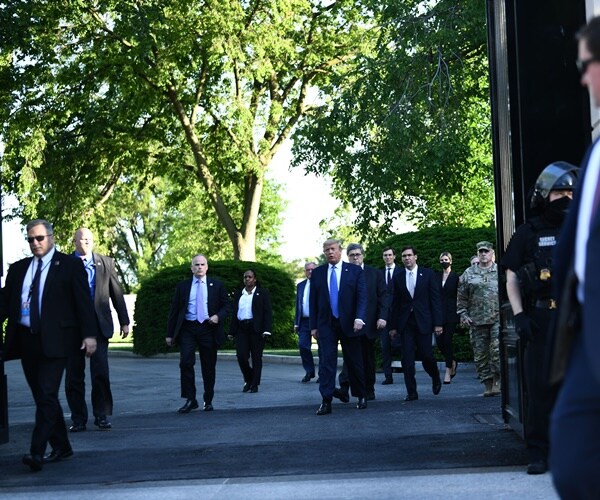 the president and his cabinet walks through a cleared lafayette park