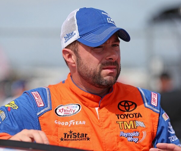 eric mcclure stands on race track