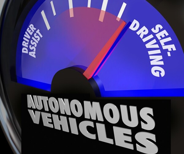 words autonomous vehicles on an automobile gauge with the needle rising past driver assist to reach self-driving

