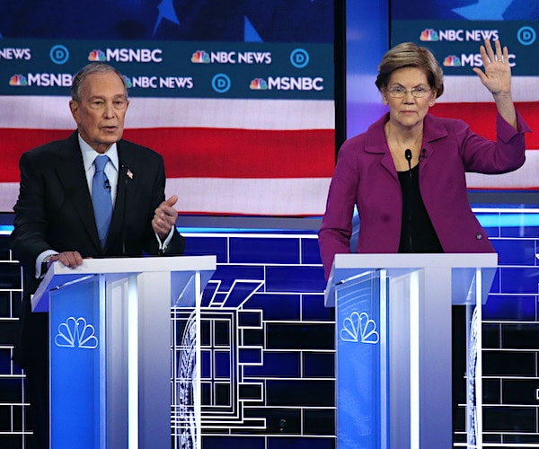 Mike Bloomberg speaks as Sen. Elizabeth Warren, D-Mass., raises her hand to chime in