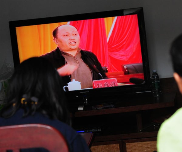 Zheng Yanxiong  is shown speaking on a tv