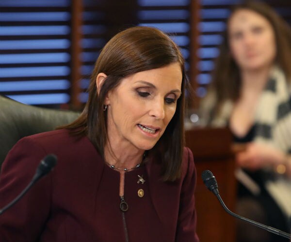 Sen. Martha McSally, in a burgundy suit dress speaks during a Senate armed service committee hearing