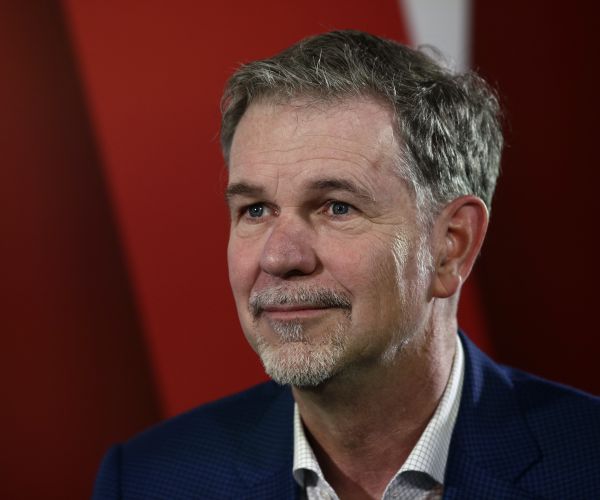 reed hastings sits and listens during a forum