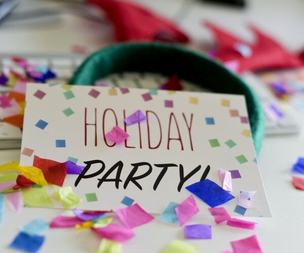 invitation says 'holiday party', confetti on a keyboard