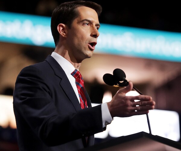 arkansas republican senator tom cotton speaks into a podium mic during a campaign rally