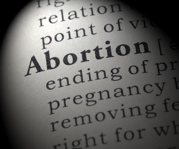 dictionary definition of the word abortion in black and white including key descriptive words