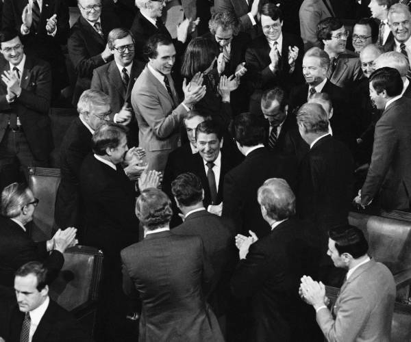 reagan shakes hands with members of the house and senate