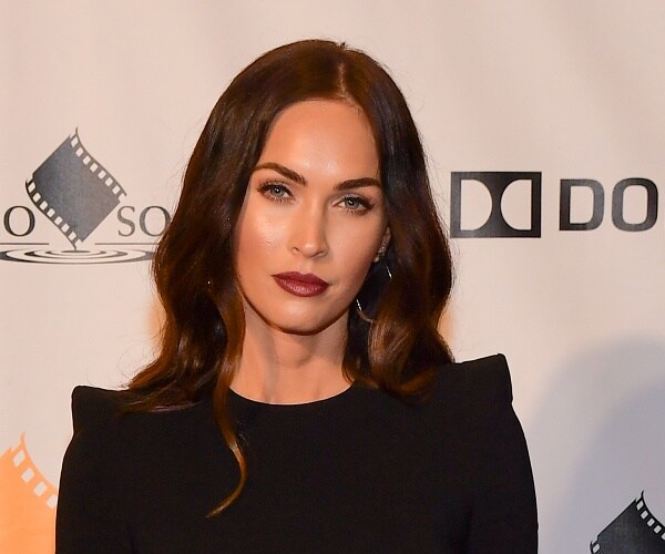 megan fox stands on red carpet