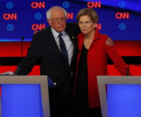 sen. bernie sanders and sen. elizabeth warren embrace after the first of two democratic presidential primary debates.