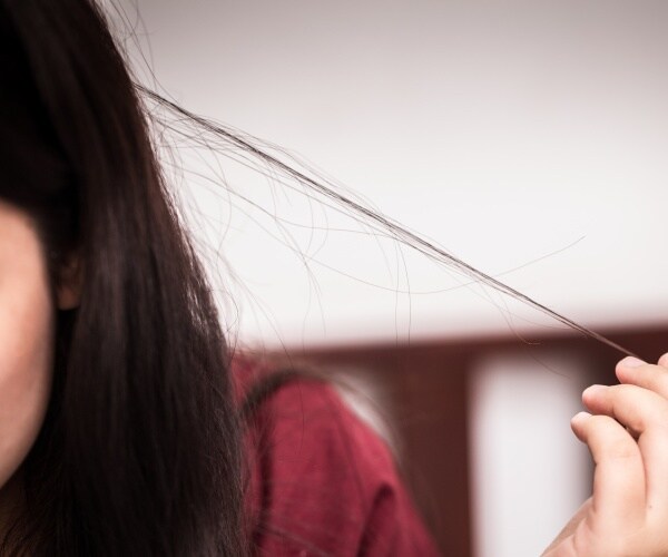 girl pulls piece of hair