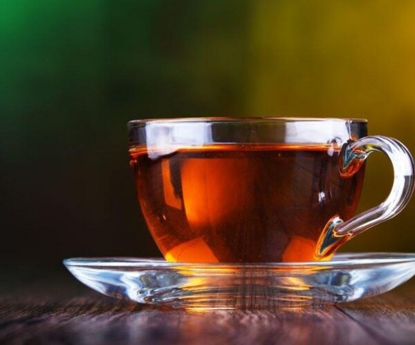 cup of dark tea in glass teacup