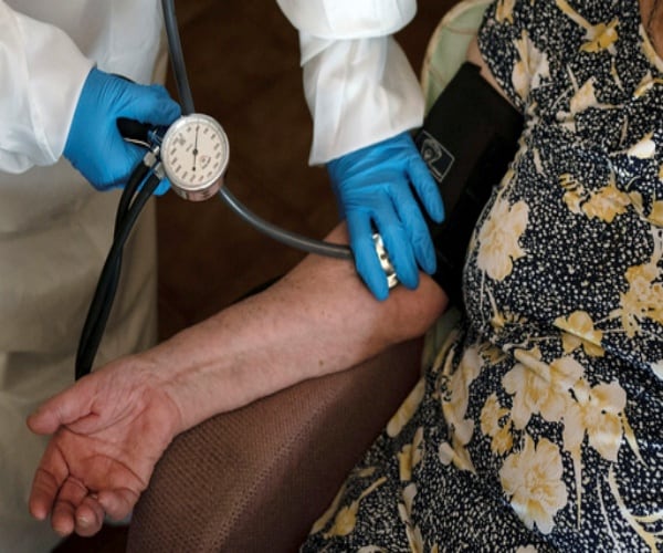 woman getting her blood pressure taken