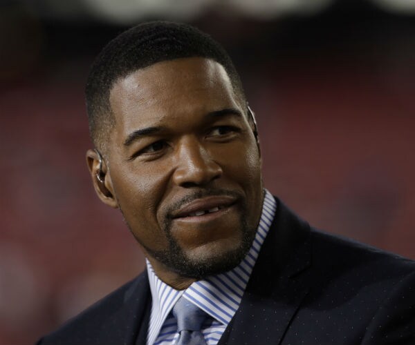 michael strahan is shown in suit, tie and dress shirt