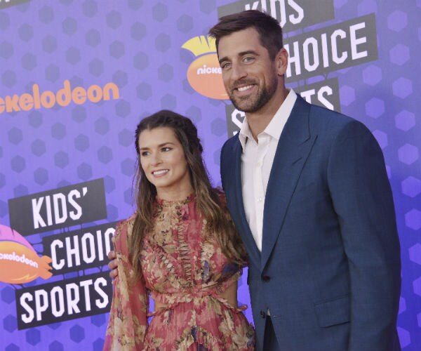 Danica Patrick and Aaron Rodgers are seen at a kids' choice sports event in 2018