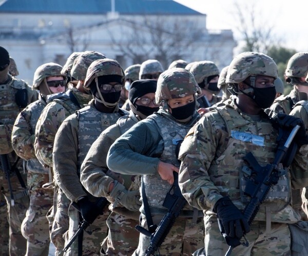 national guardsmen stand outside in uniform in dc