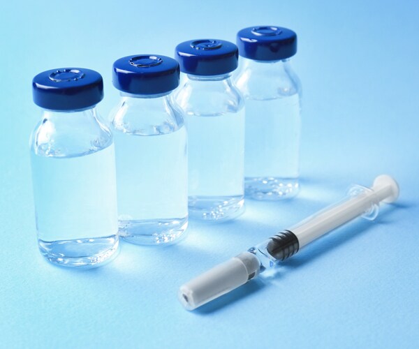 vaccine vials and a syringe