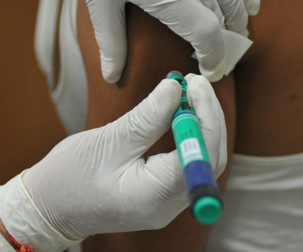 a person receives an insulin shot