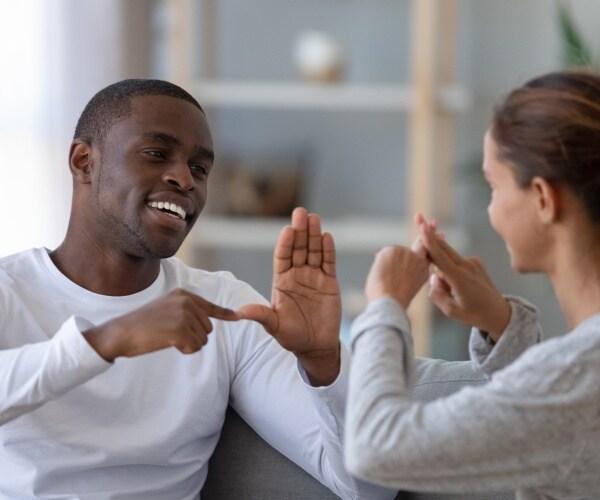 man and woman signing to each other