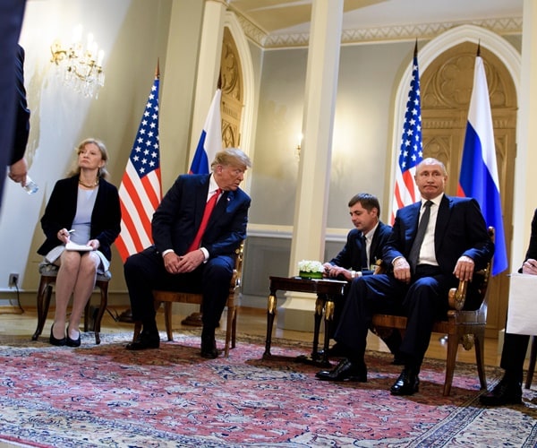 president donald trump and president vladimir putin sit with their translators before a meeting in helsinki.