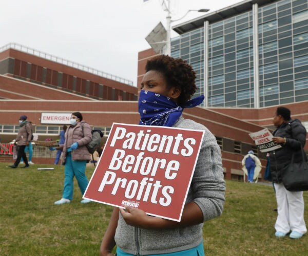 a nurse is shown holding a sign that says patients before profits