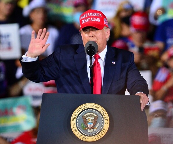 donald trump speaks from behind podium