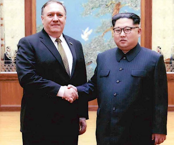 Secretary of State Mike Pompeo and North Korea's Kim Jong Un shake hands during a diplomatic photo opportunity